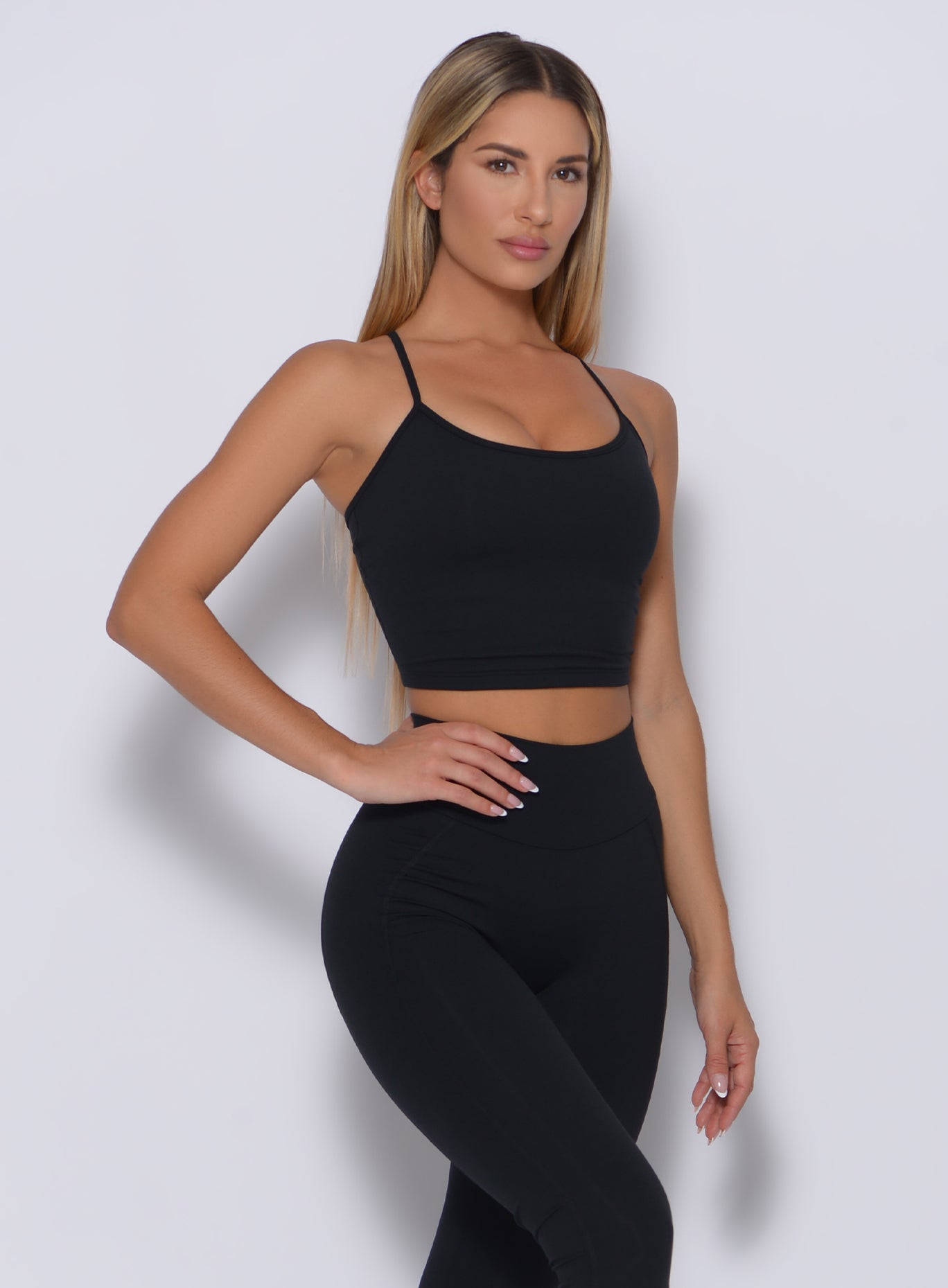 Right side view of a model angled right wearing our black relax long Best Regards, and a matching high waist leggings 