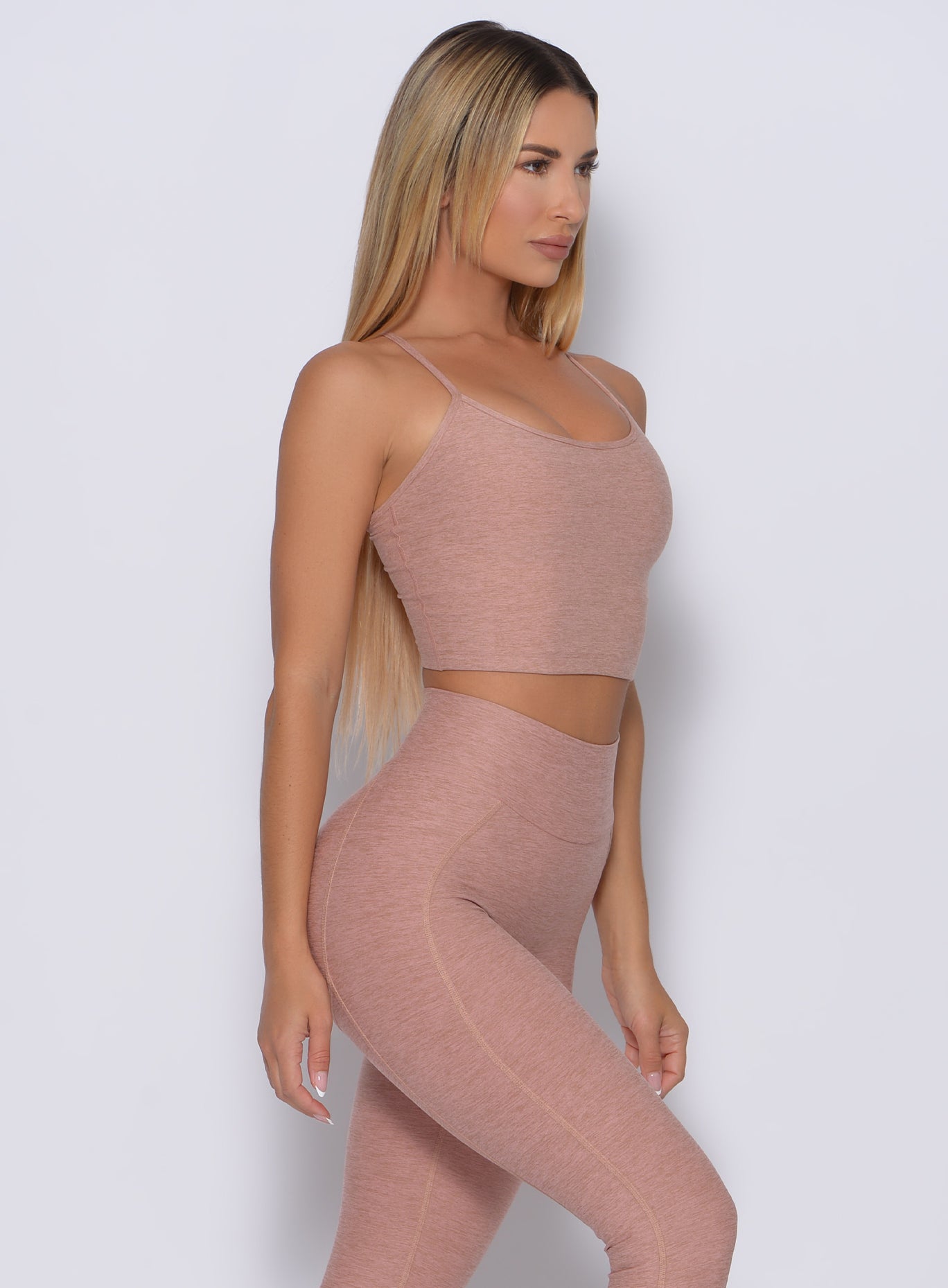 right side profile view of a model in our relax long bra in latte color and a matching leggings