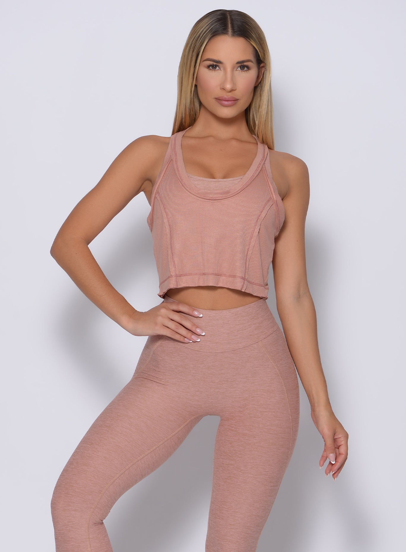 Model facing forward wearing  our rib crop tank in frappe color and a matching leggings