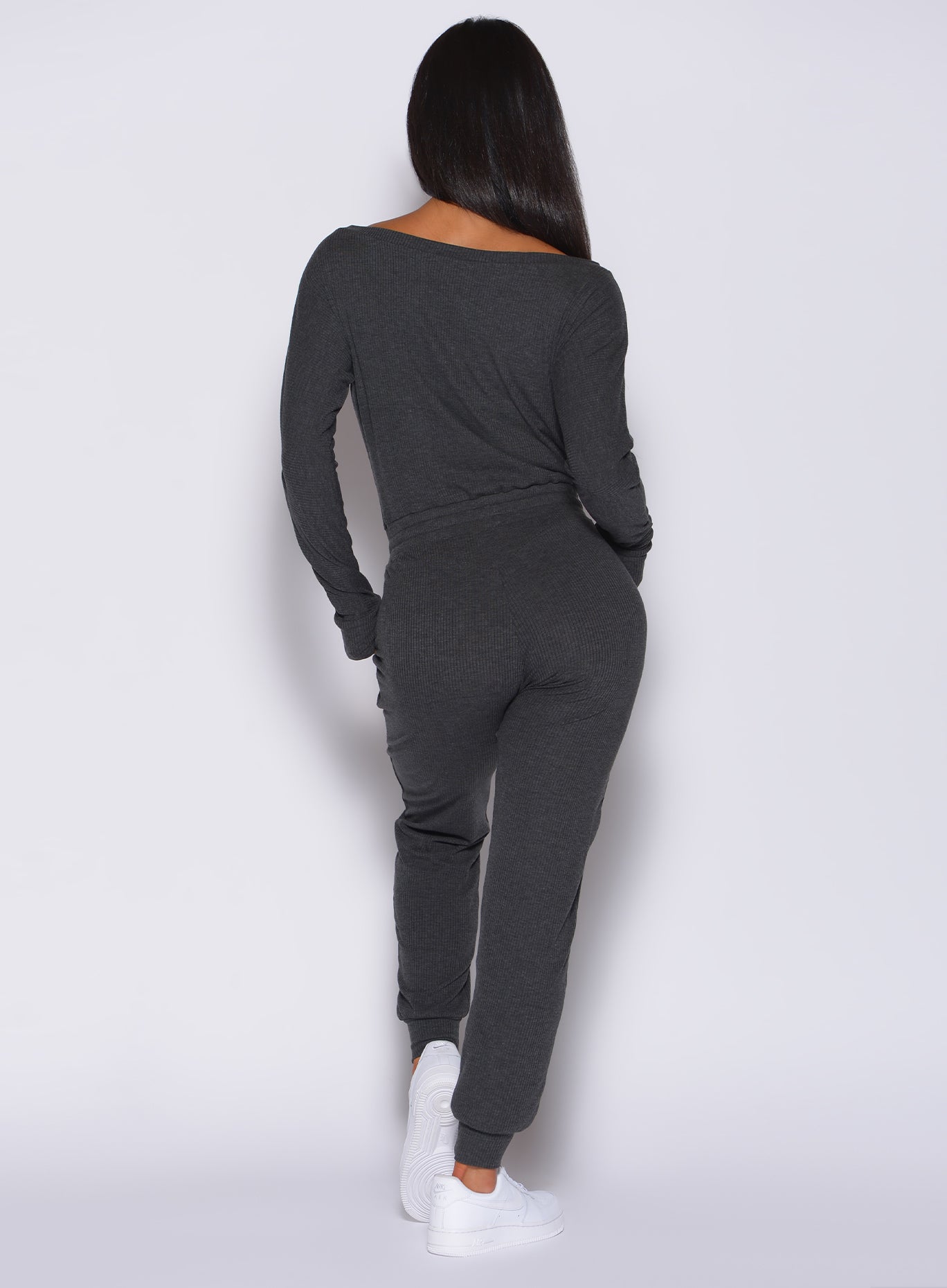 Back view of a model in our Rib Jumpsuit in charcoal color