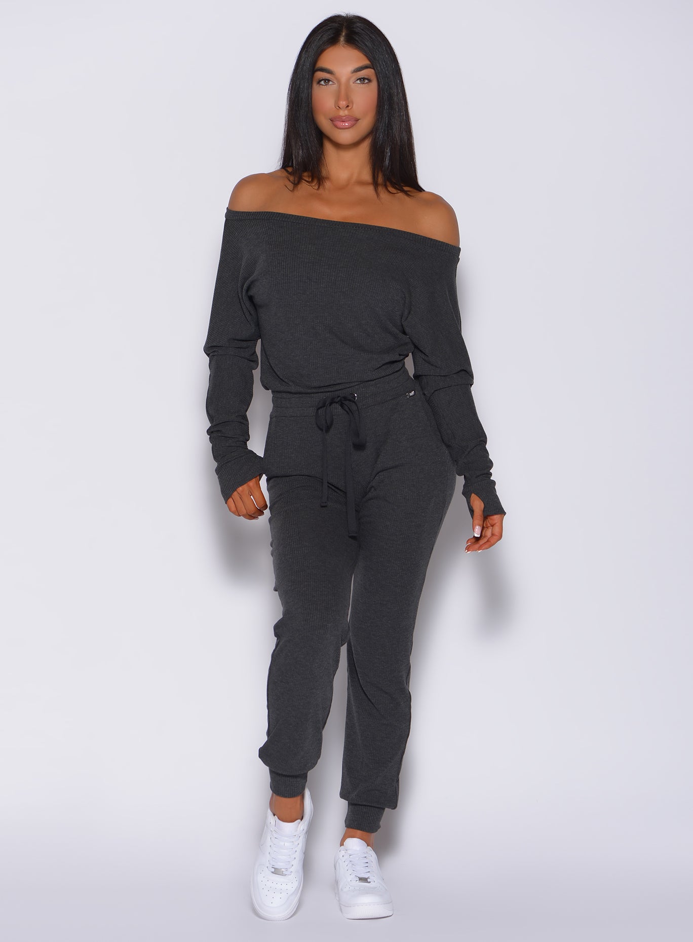 Front view of a model in our Rib Jumpsuit in charcoal color 