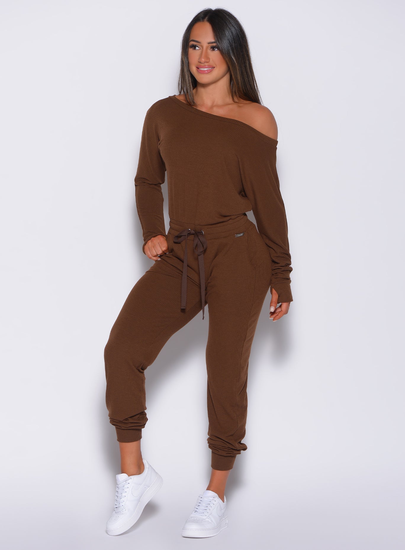 front profile view of a model in our rib jumpsuit in expresso color 