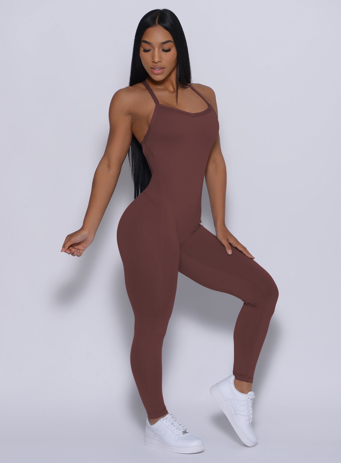 Right side profile view of a model angled right wearing our sculpted bodysuit in chocolate color