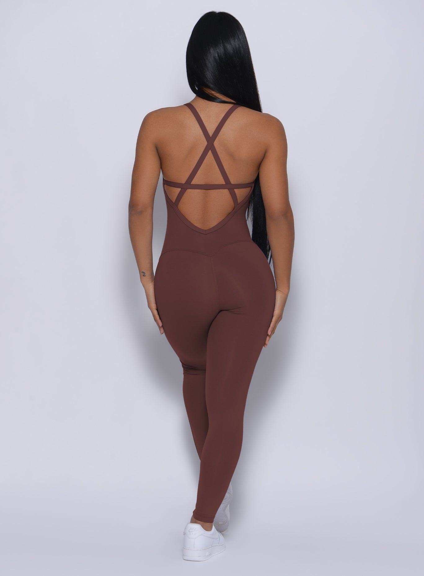 Back profile view of a model in our sculpted bodysuit in chocolate color