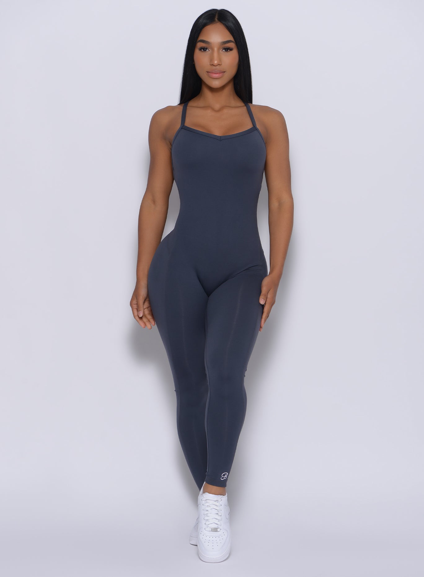front profile view of a model in our sculpted bodysuit in summit gray color