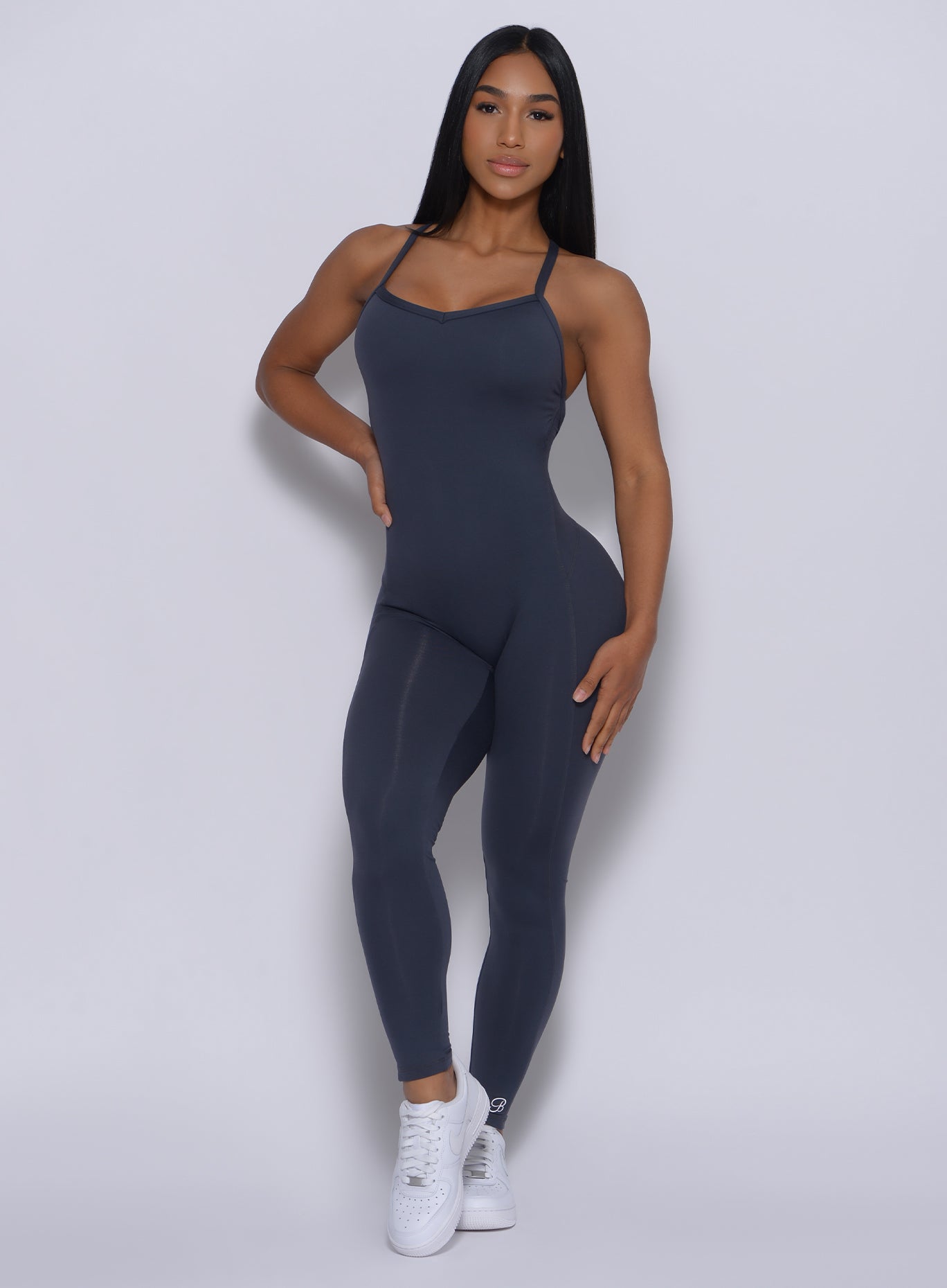 Moden facing forward wearing our sculpted bodysuit in summit gray color