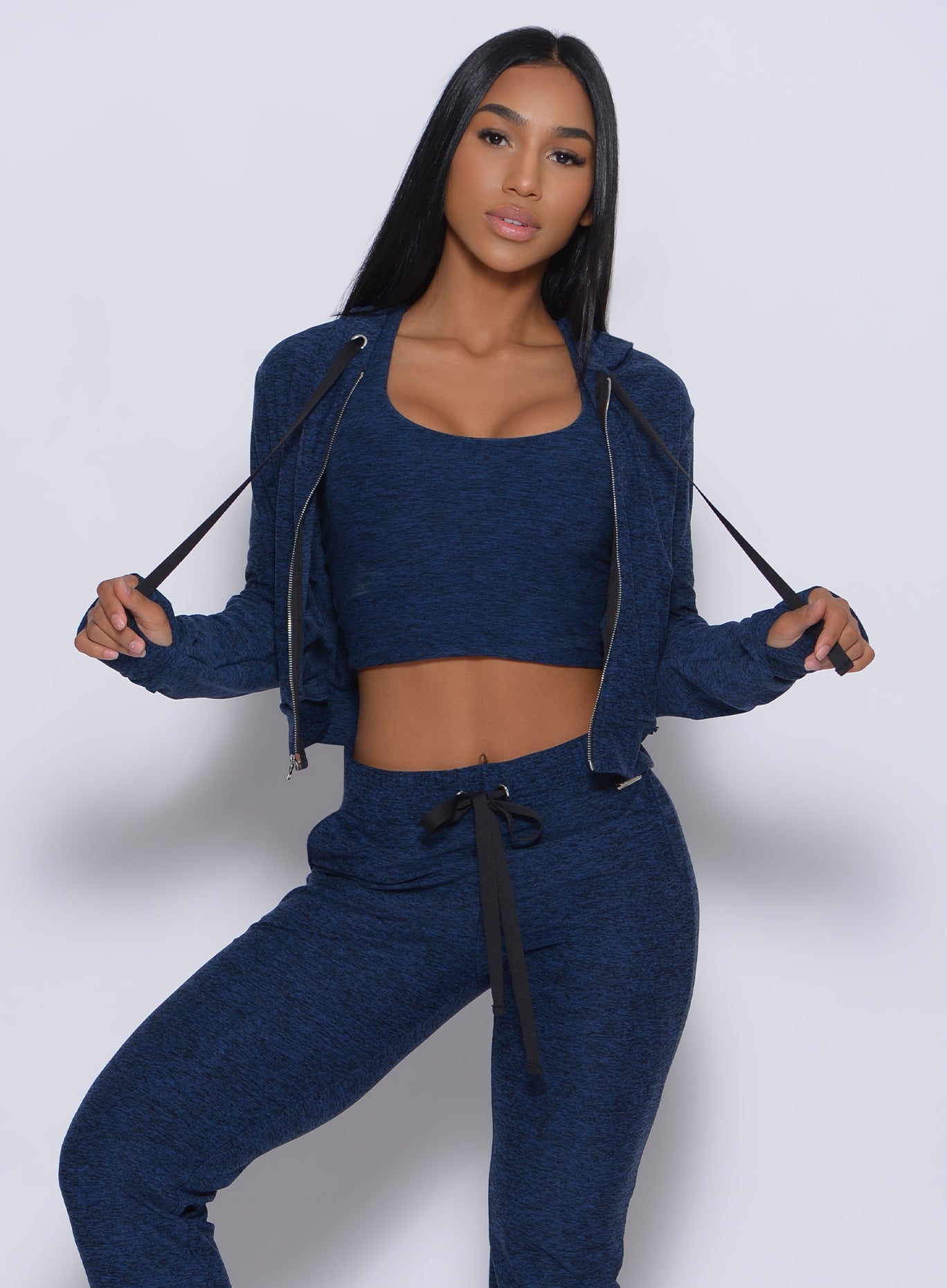Front profile view of a model in our signature jacket in sapphire blue color and a matching joggers