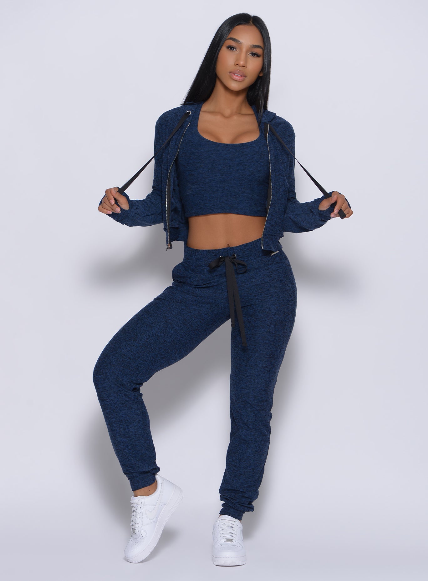 Model facing forward wearing our signature jacket in sapphire blue color and a matching joggers
