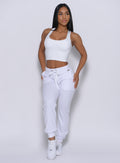 Front  profile view of the model wearing our white elevated tank bra and a matching joggers