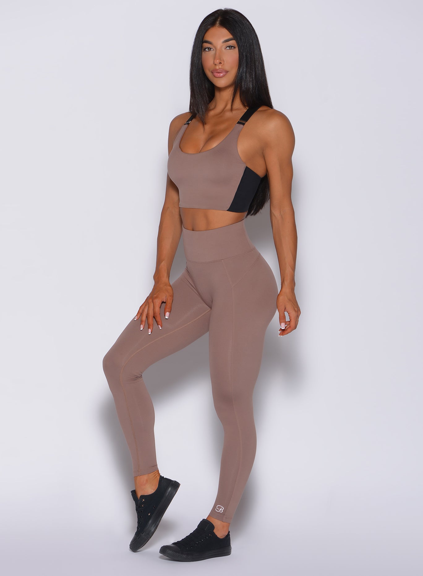 Left side profile picture of a model in our snatched waist leggings in cocoa color and a matching bra