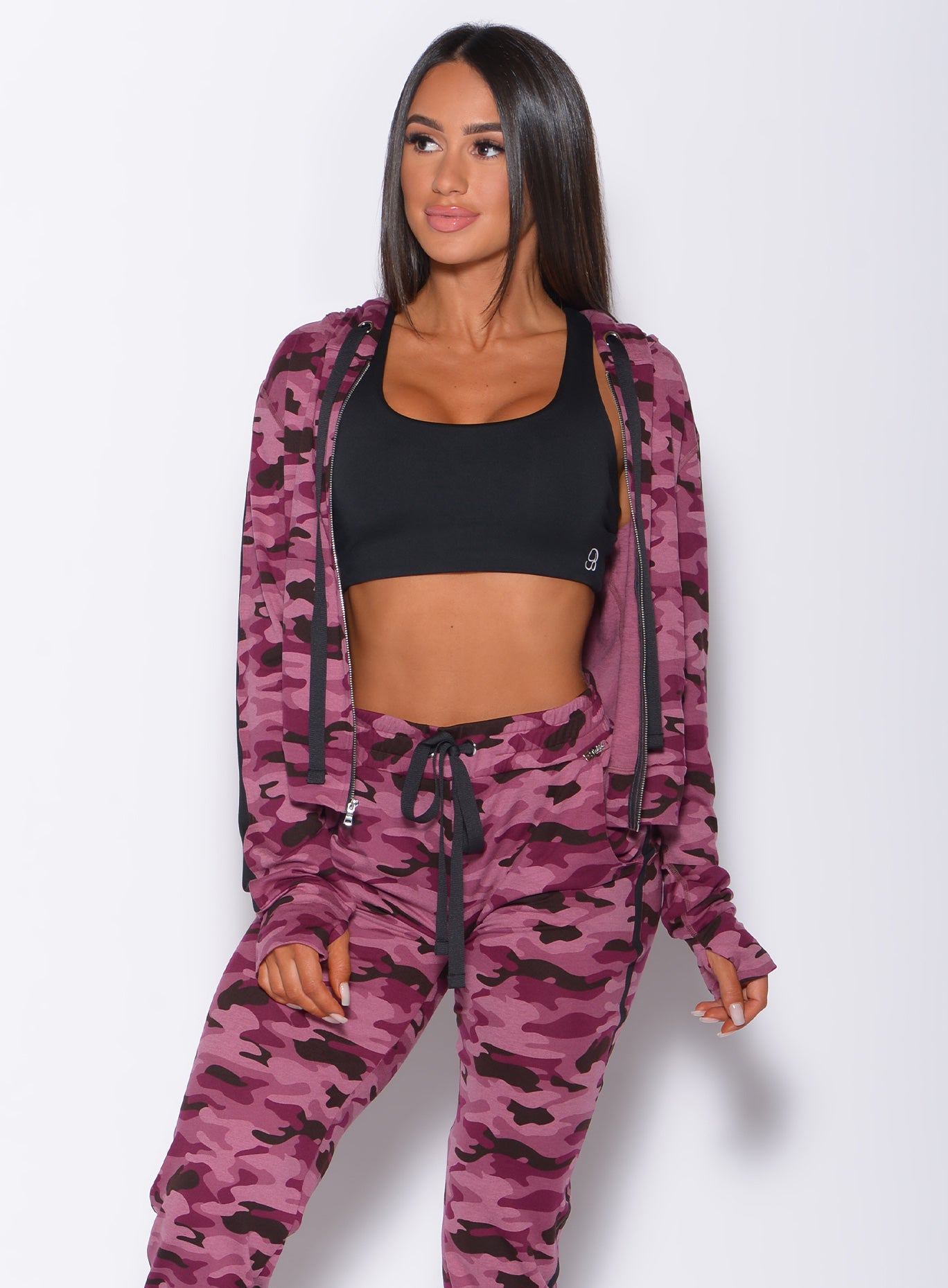 Front profile view of a model in our dream jacket in Purple Power Camo color and a matching joggers