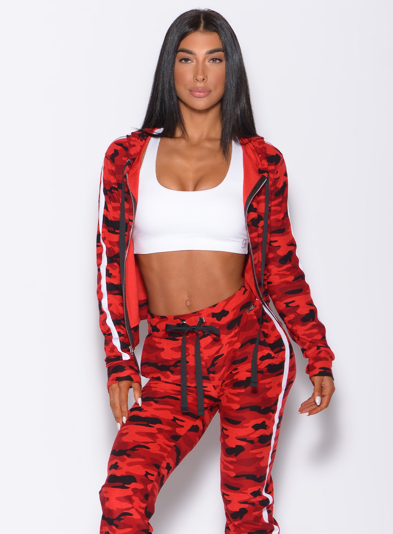 Front profile view of a model in our dream jacket in Red Rebel Camo color and a matching joggers