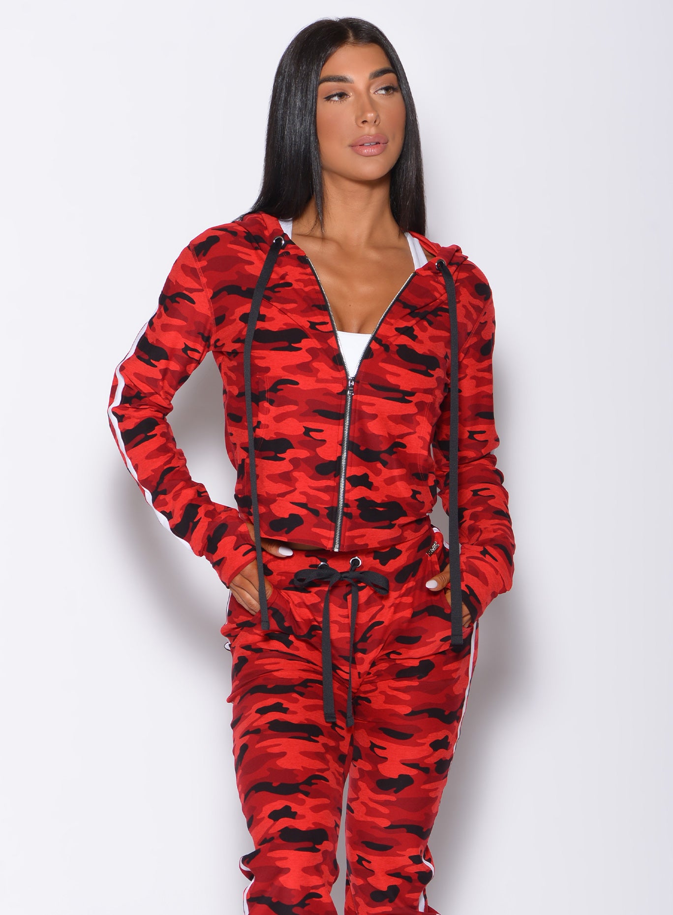 Front profile view of a model wearing our dream jacket in Red Rebel Camo color and a matching joggers