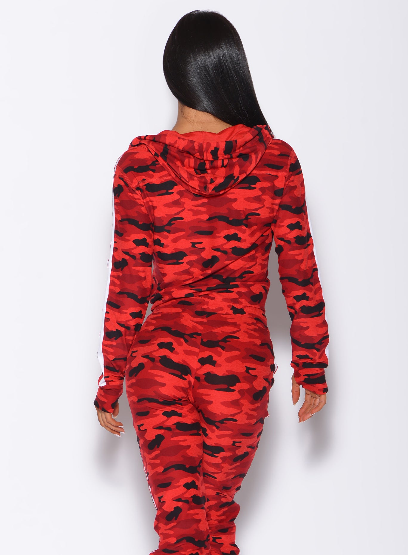 Back profile view of a model wearing our dream jacket in Red Rebel Camo color and a matching joggers