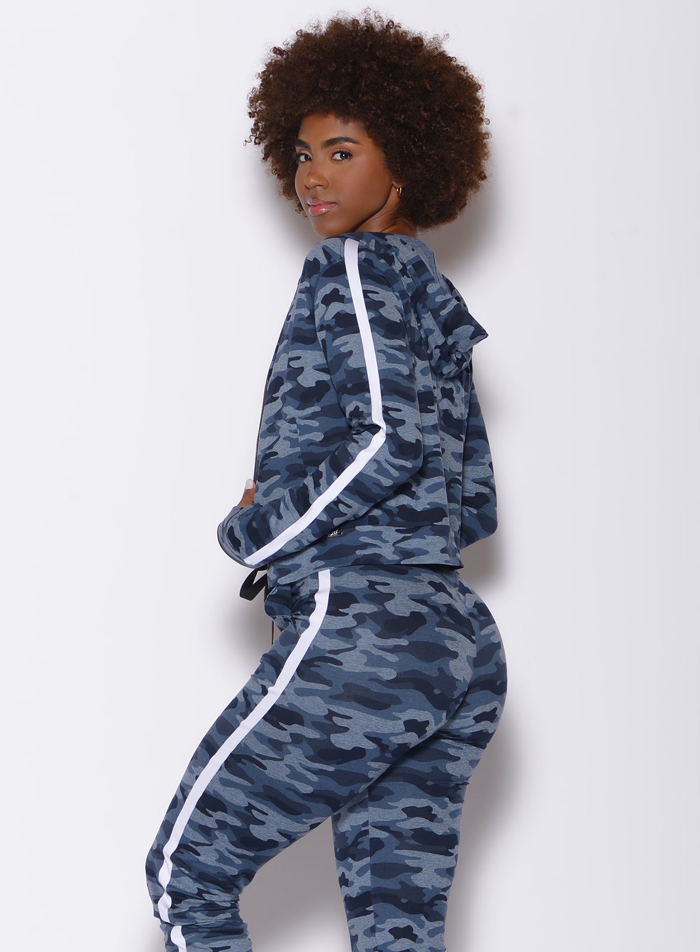 Left side profile view of a model in our dream jacket in Blue Blast Camo color and a matching joggers
