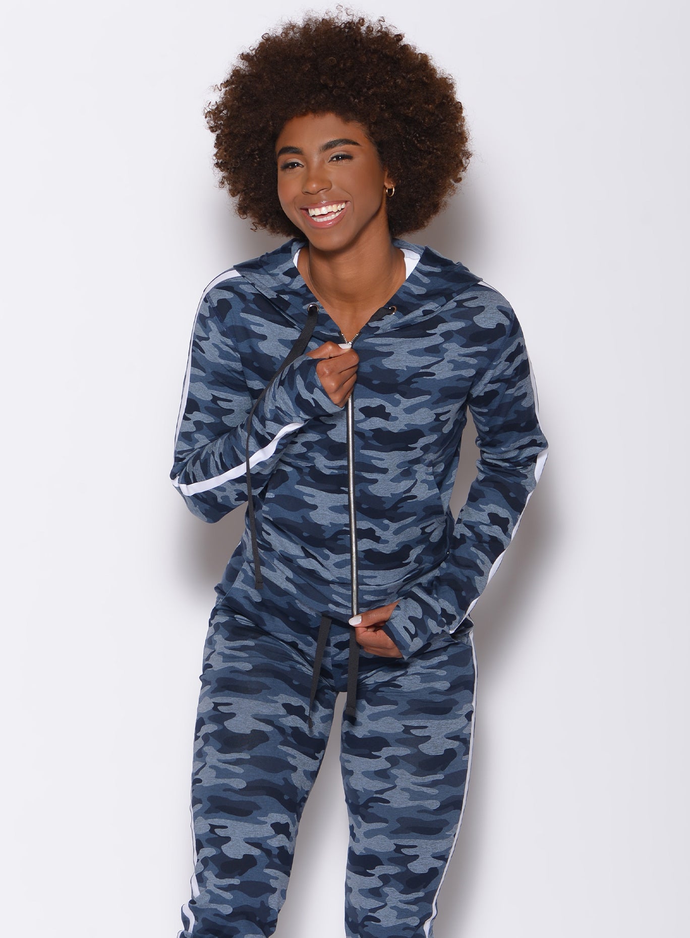 Front profile view of a model wearing our dream jacket in Blue Blast Camo color and a matching joggers