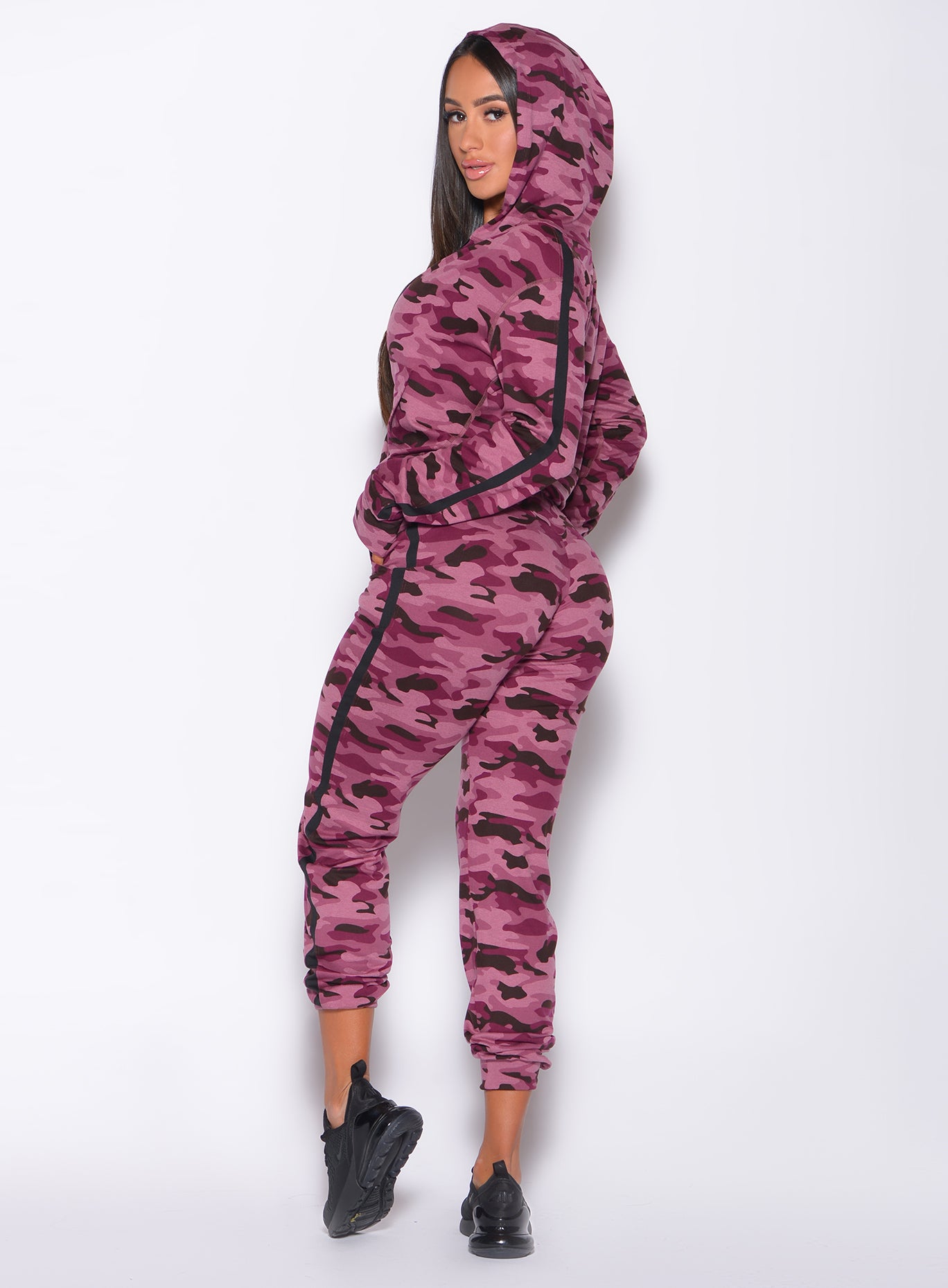 Left side profile view of a model in our dream joggers in Purple Power Camo color and a matching jacket