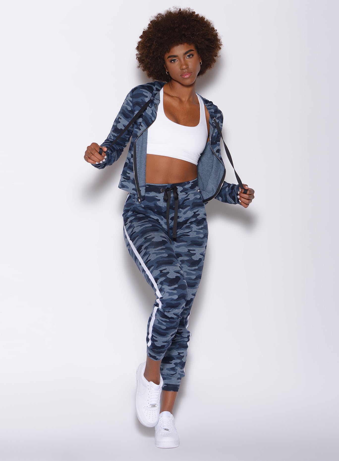 Front profile view of a model in our dream joggers in Blue Blast Camo color and a matching jacket
