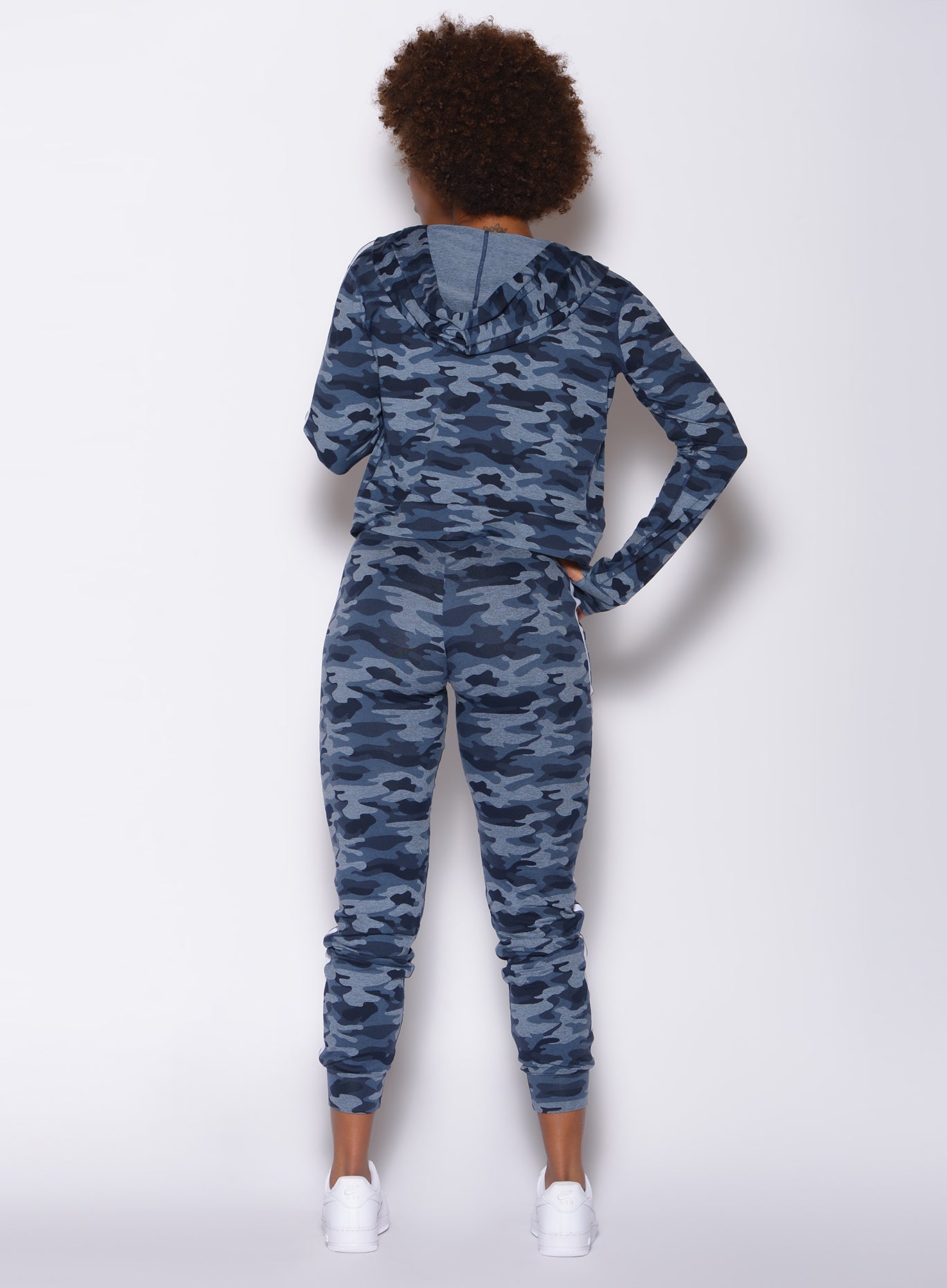 Back profile view of a model in our dream joggers in Blue Blast Camo color and a matching long sleeved jacket