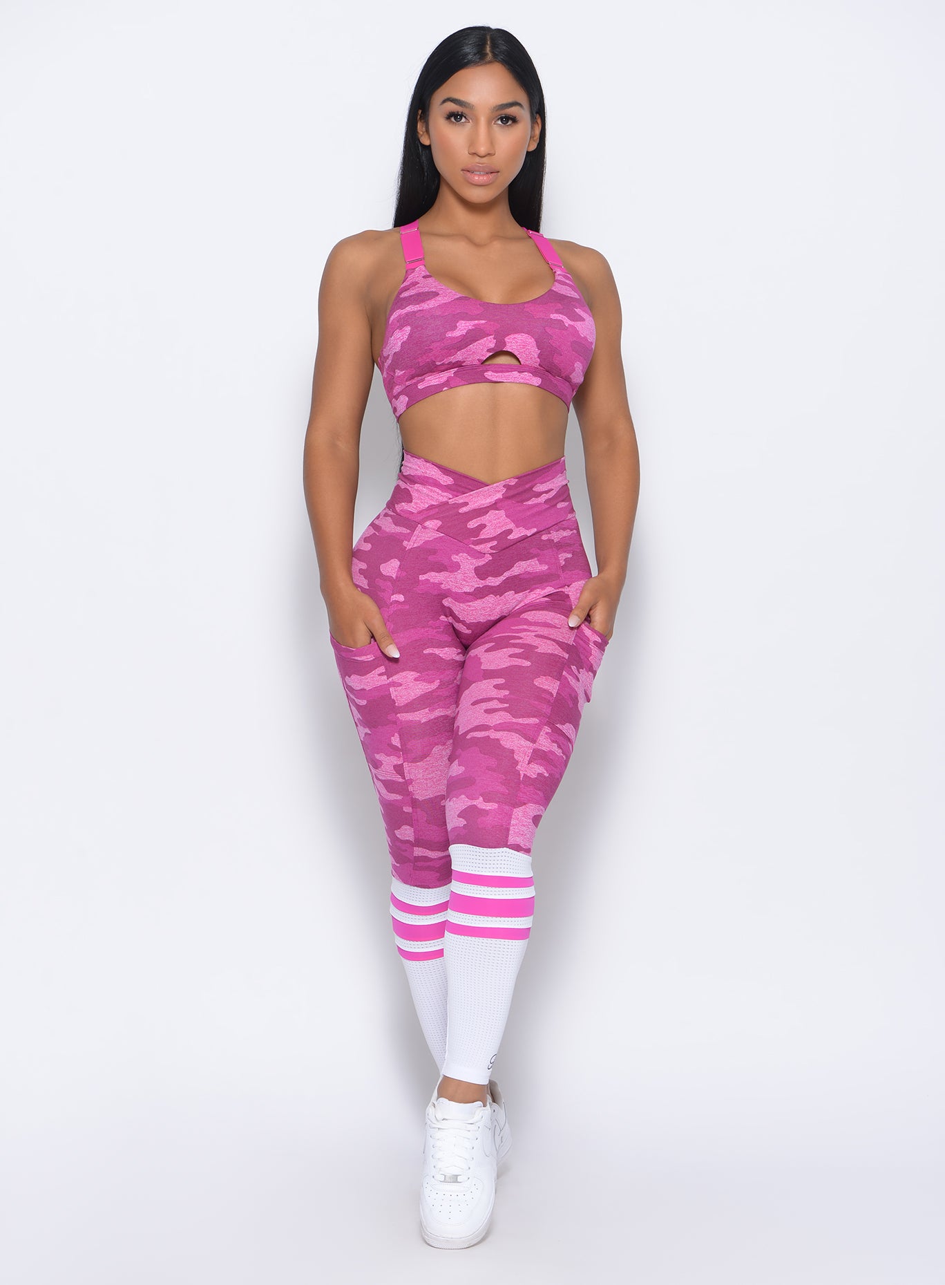 Front profile view of the model in our pink camo contour sock leggings and a matching bra 