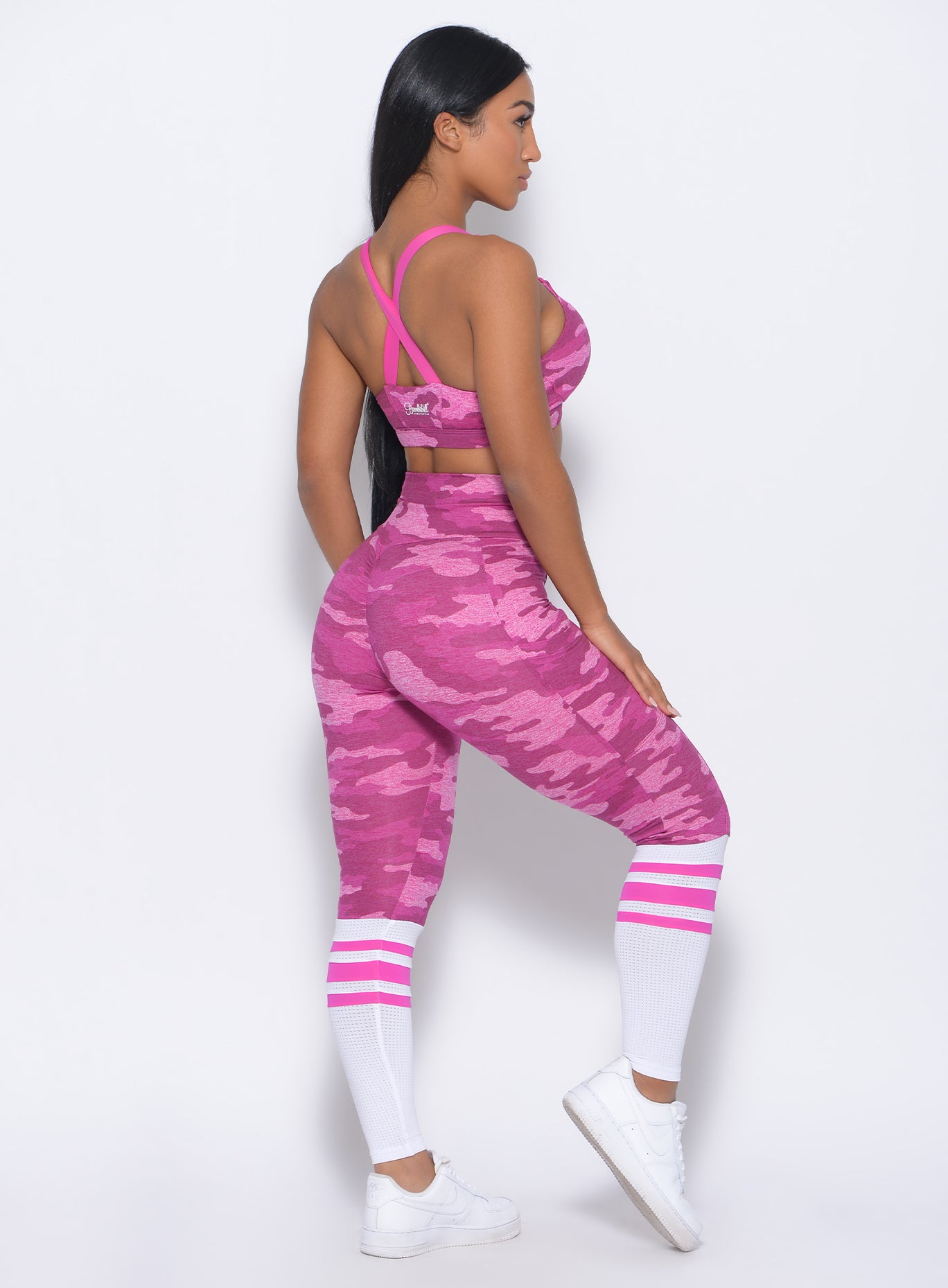 Right side  view of the model facing forward in our contour sock leggings in pink camo and a matching bra