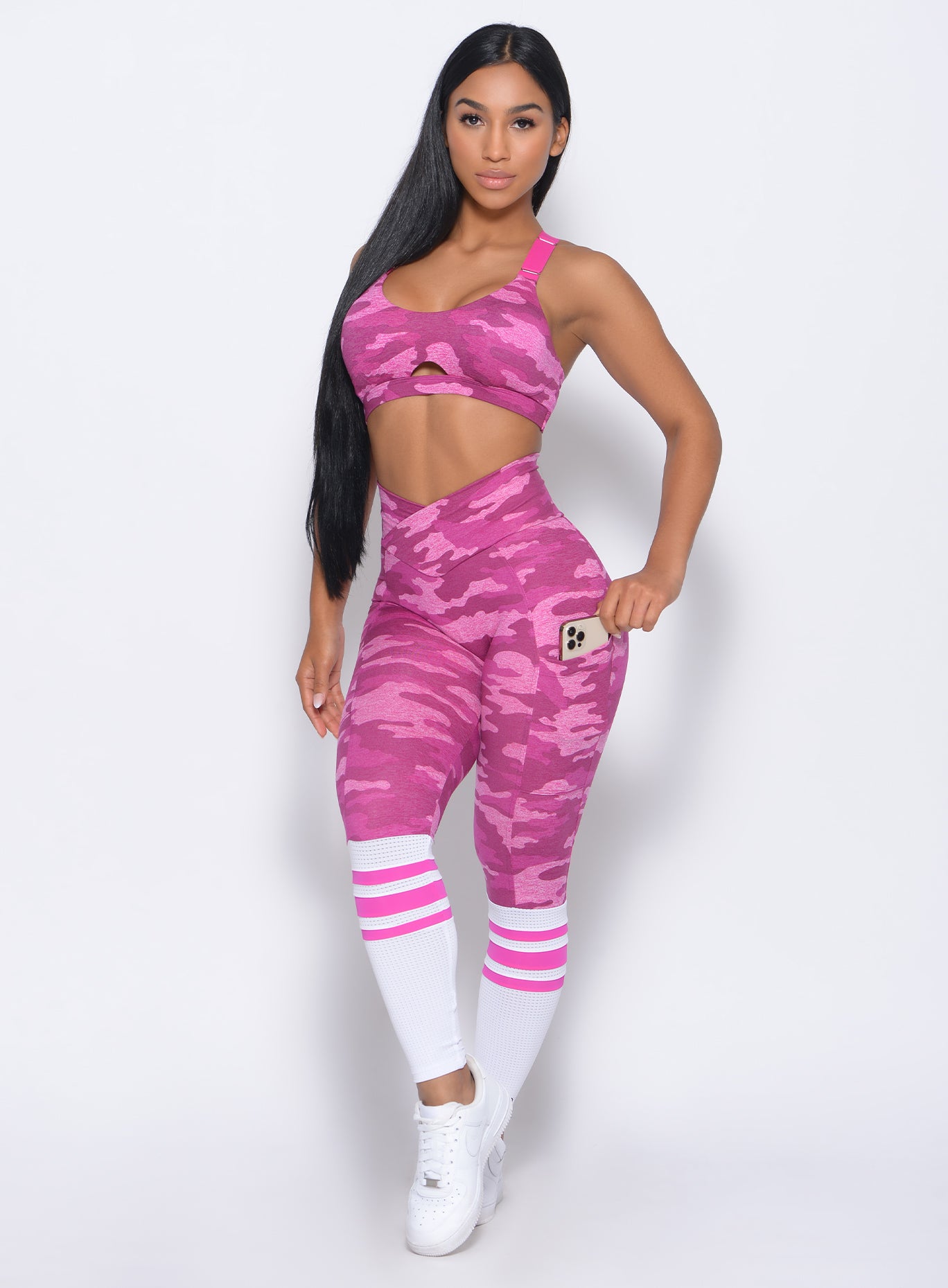 Front profile view of the model in our contour sock leggings in pink camo and a matching bra
