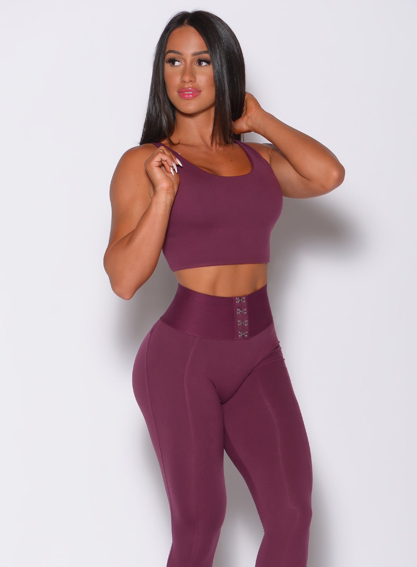 Front profile view of a model in our impact sports bra in majestic purple color and a matching leggings