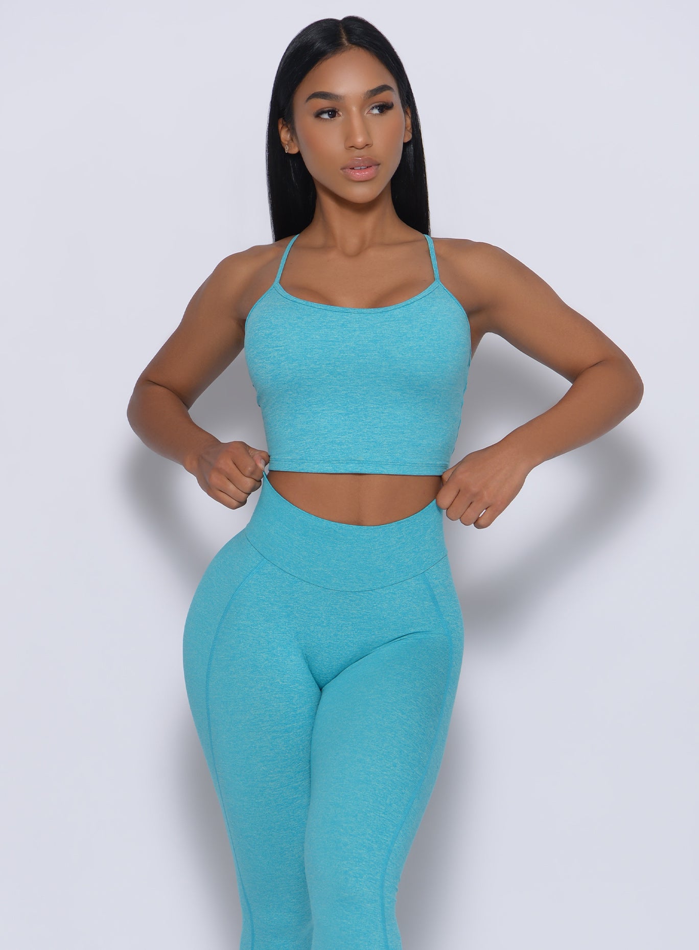 Model facing forward wearing our relax sports bra in crystal blue color and a matching leggings