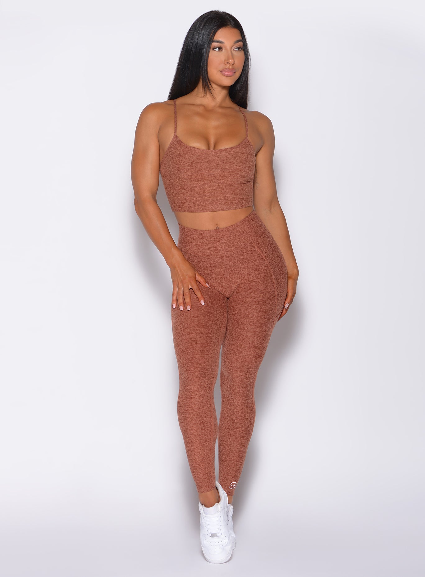 Front profile view of a model in our relax long bra in spiced chai color and a matching high rise leggings