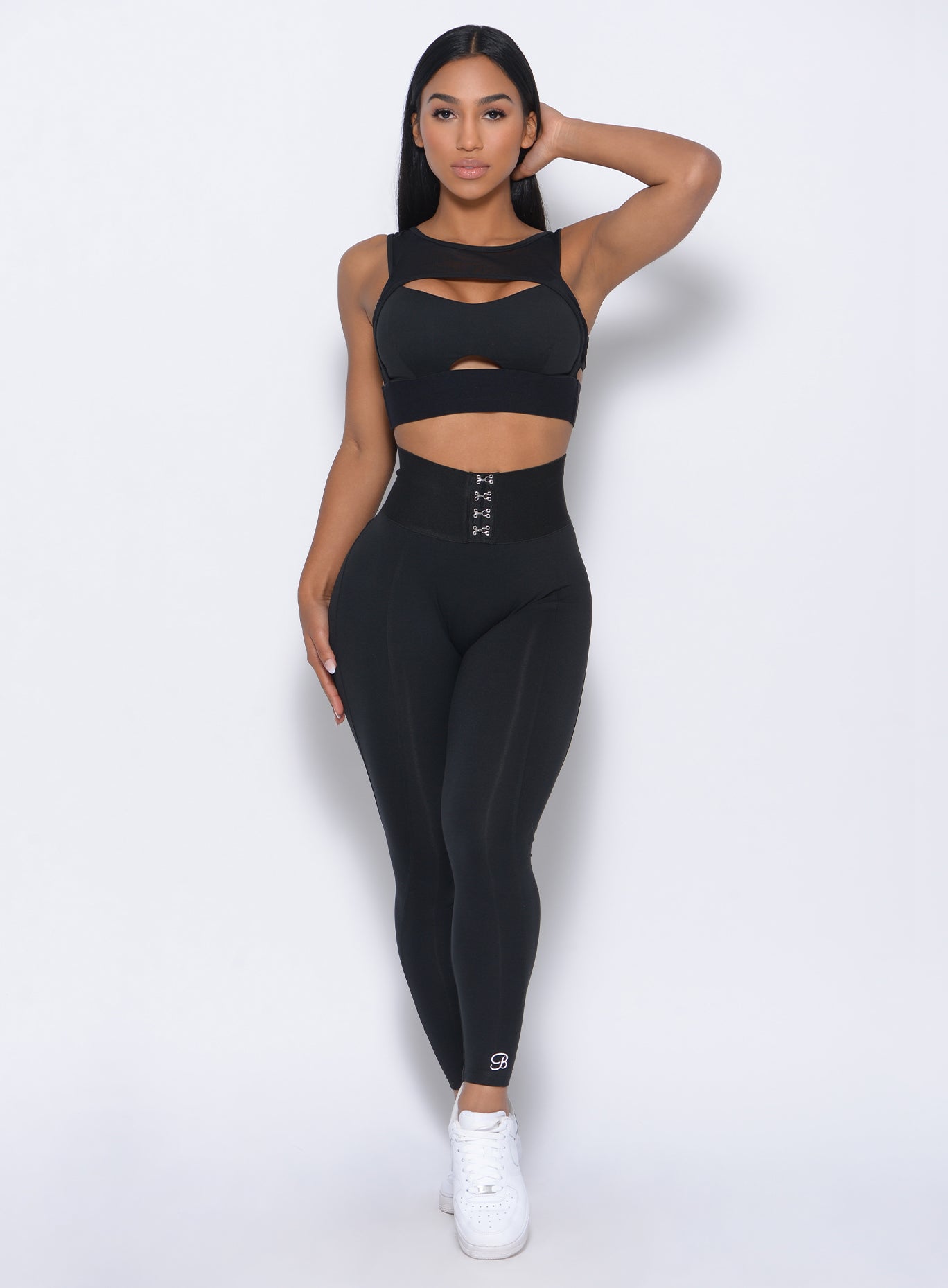 Model facing forward in our black waist cincher leggings and a matching bra