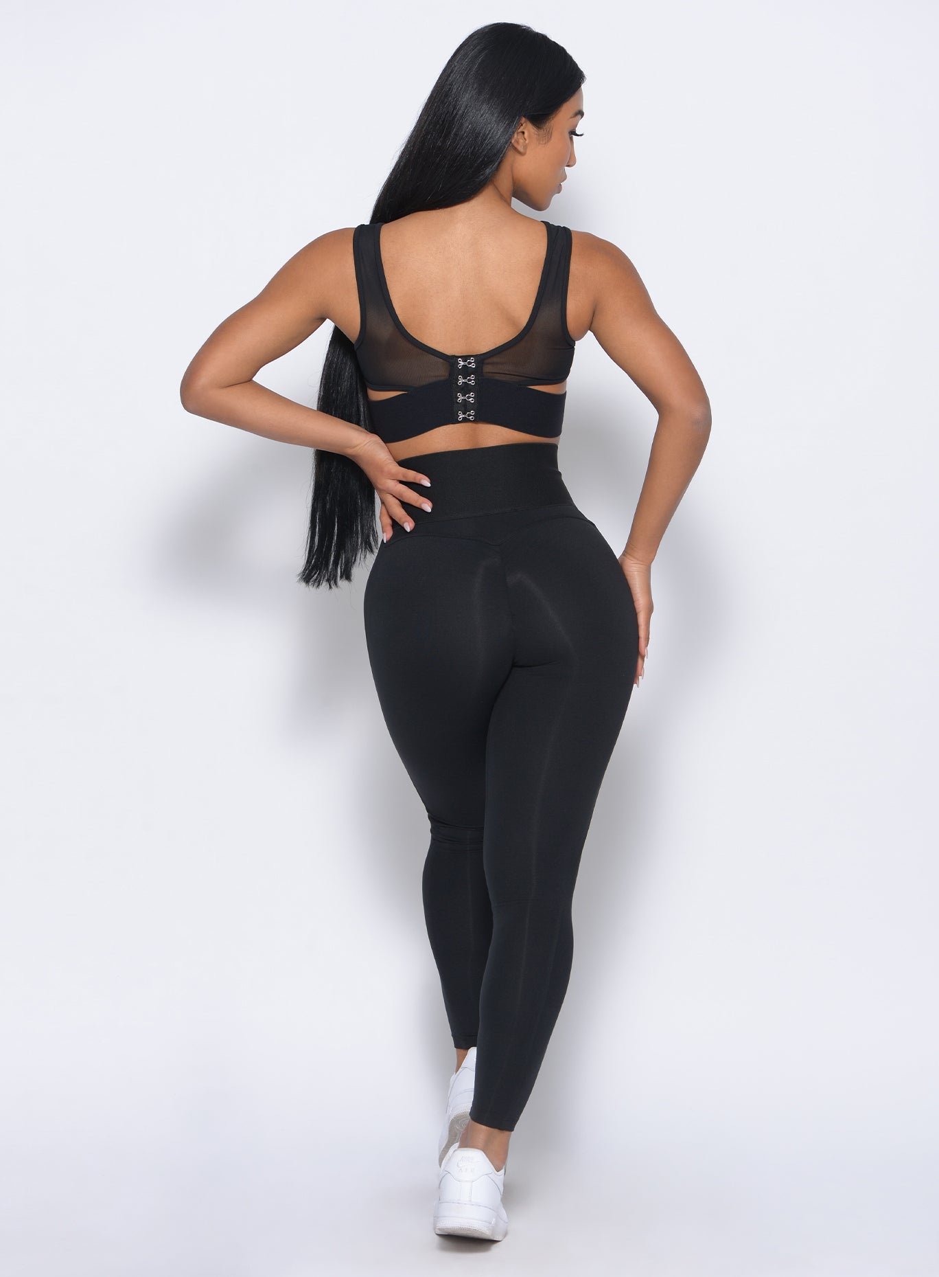 Picture of a model facing backward in our volume sports bra and a matching leggings 