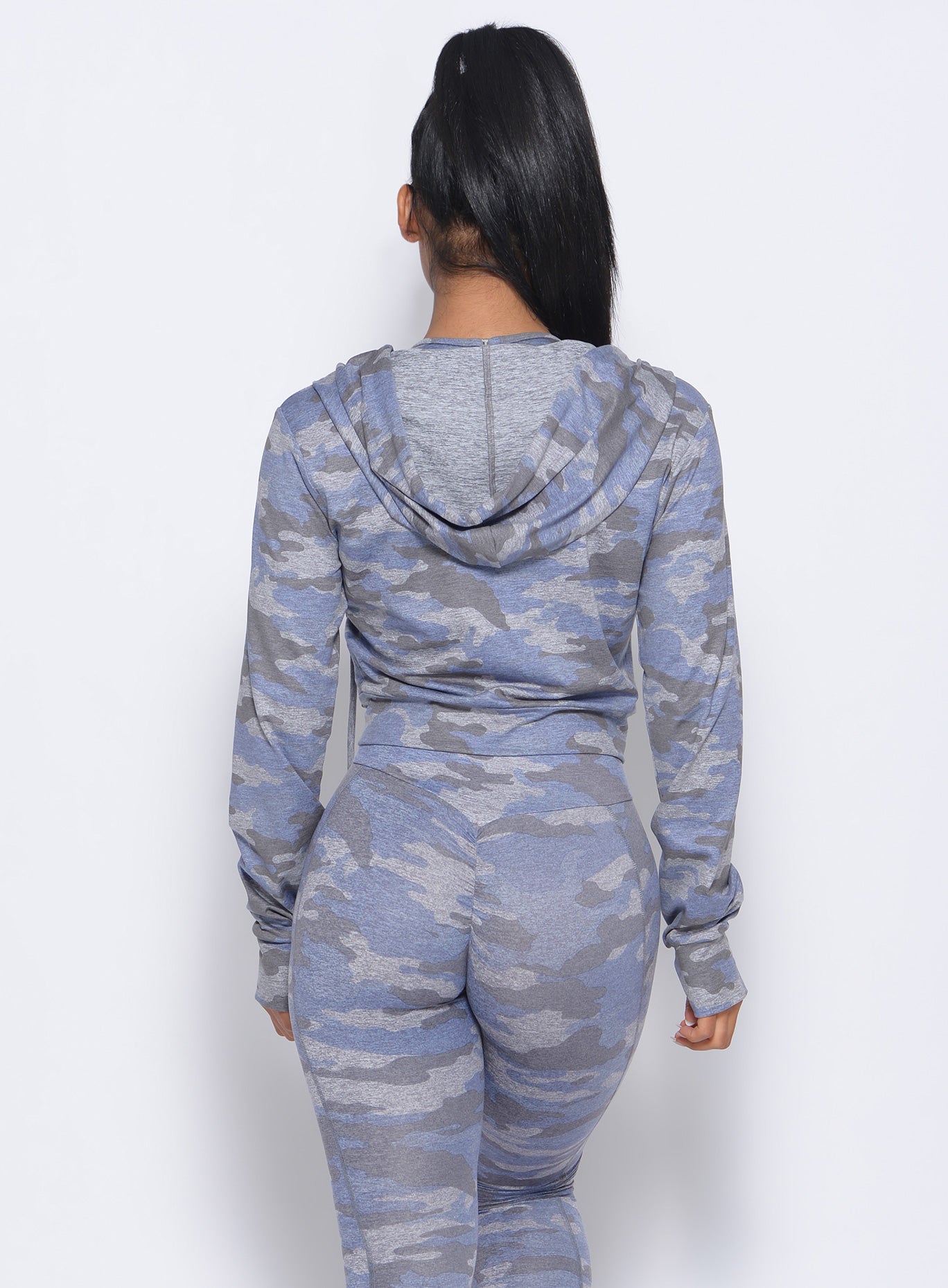 back profile view of the model wearing our silver camo signature jacket and a matching leggings