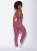 Right side view of a model facing to her right wearing our Chevron Leggings and Chevron Sports Bra in Rose Wine color