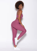 Right side view of a model facing to her right with her right leg up and bent wearing our Chevron Leggings and Chevron Sports Bra in Rose Wine color