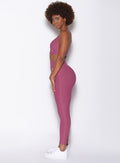Left side view of model wearing the Chevron Leggings and Chevron Sports Bra in Rose Wine color
